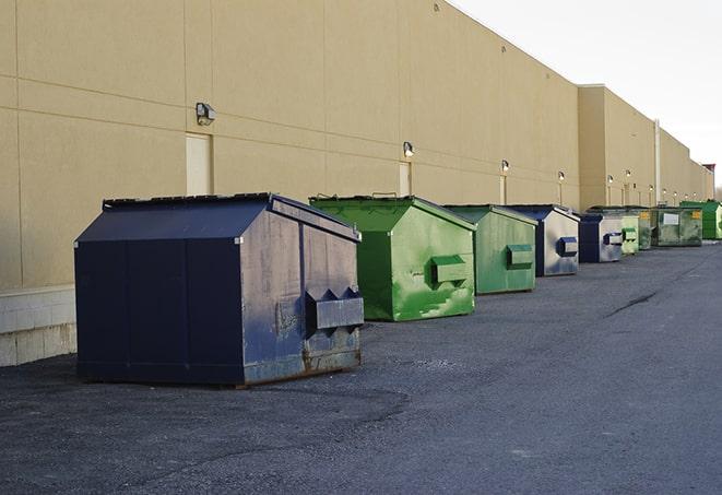 metal waste containers sit at a busy construction site in Brownsville